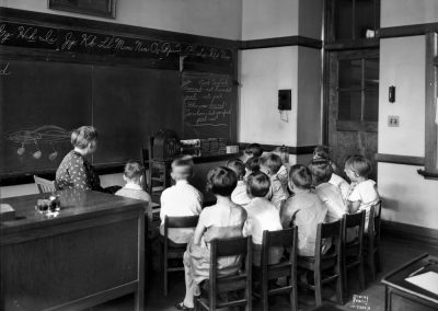 Image school children and teacher listen to the radio in 1931