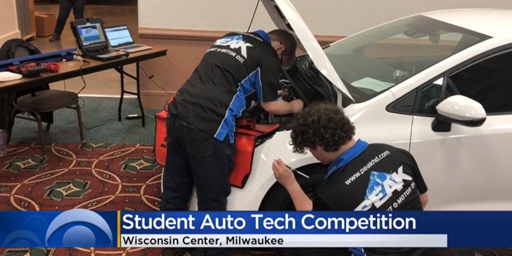 Students work on a car at Milwaukee auto show